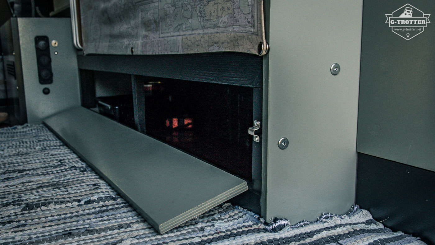 The small compartment of the cupboard is accessible through a flap.