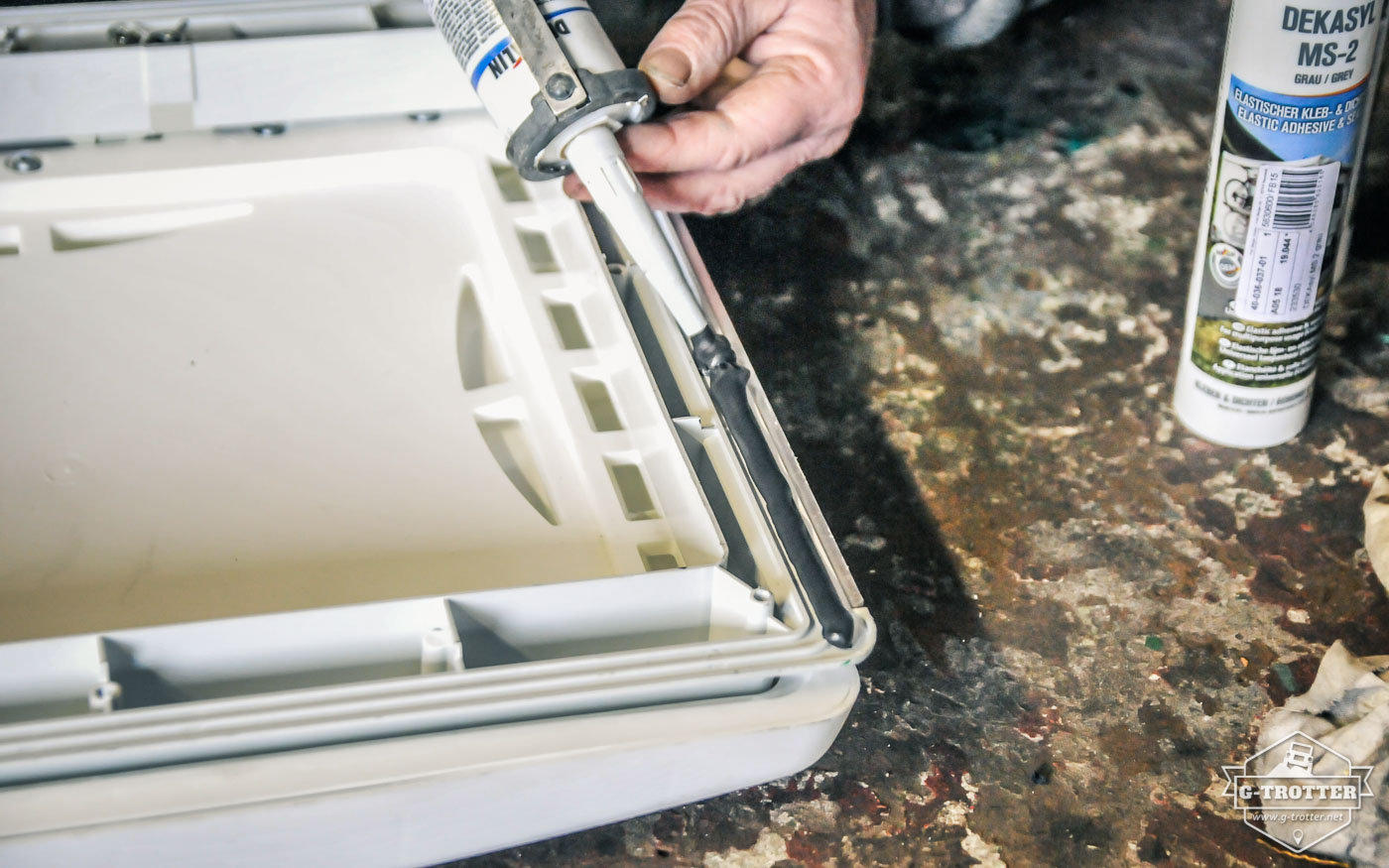 Applying adhesive and sealant on the new roof hatch. 