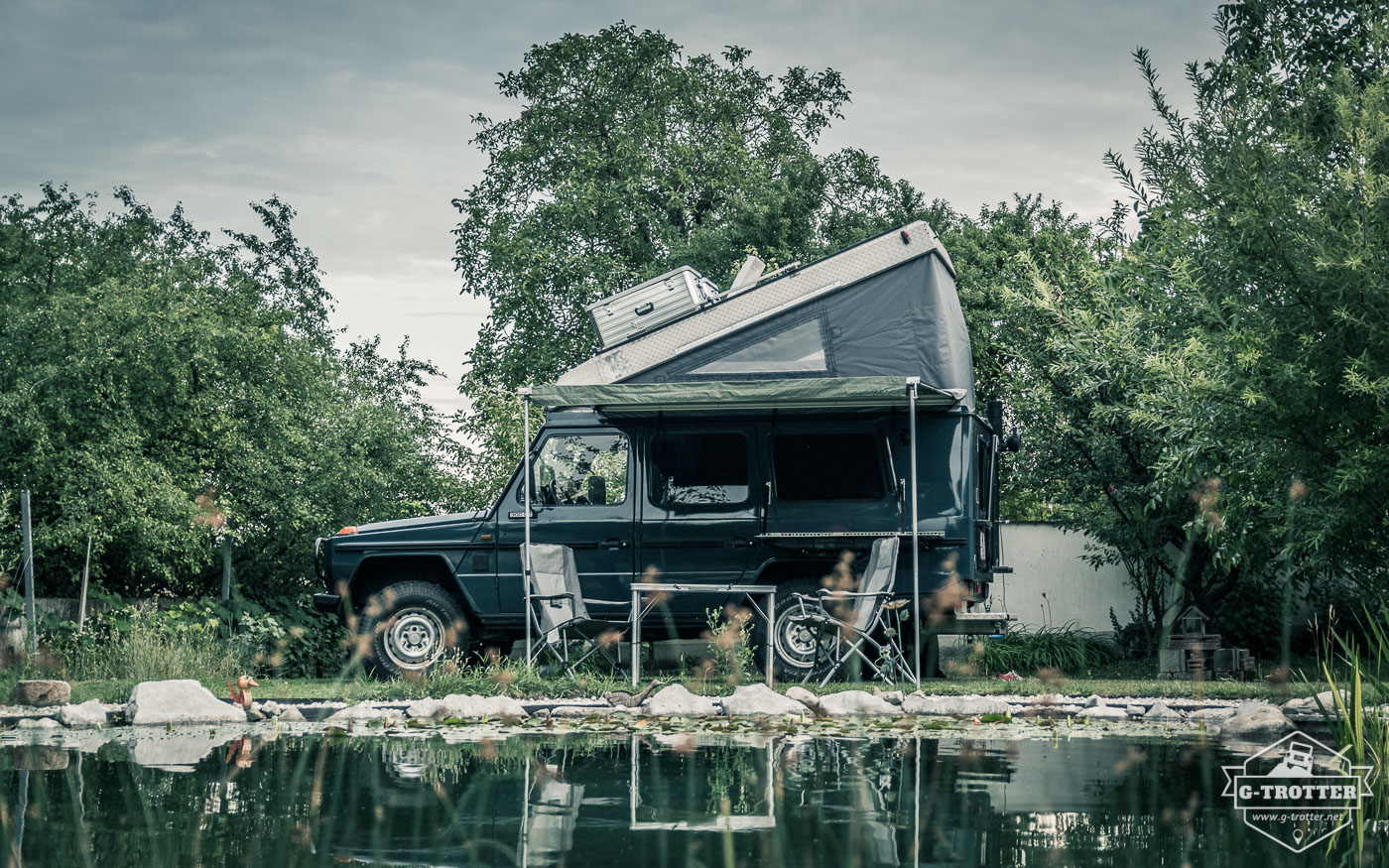 The car with set up awning and open roof. 