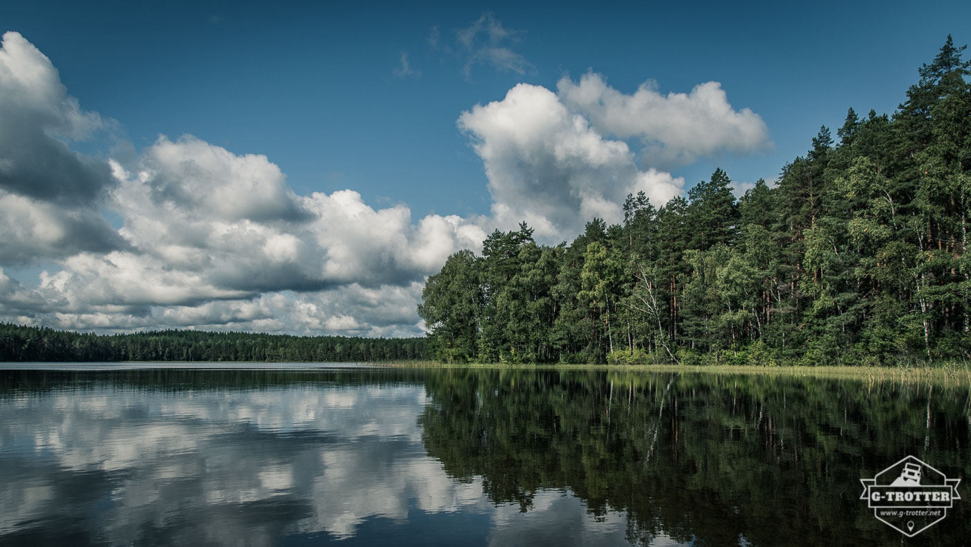 A typical sight in Lithuania: glassy lakes, lush forests and impressive clouds on a blue sky.