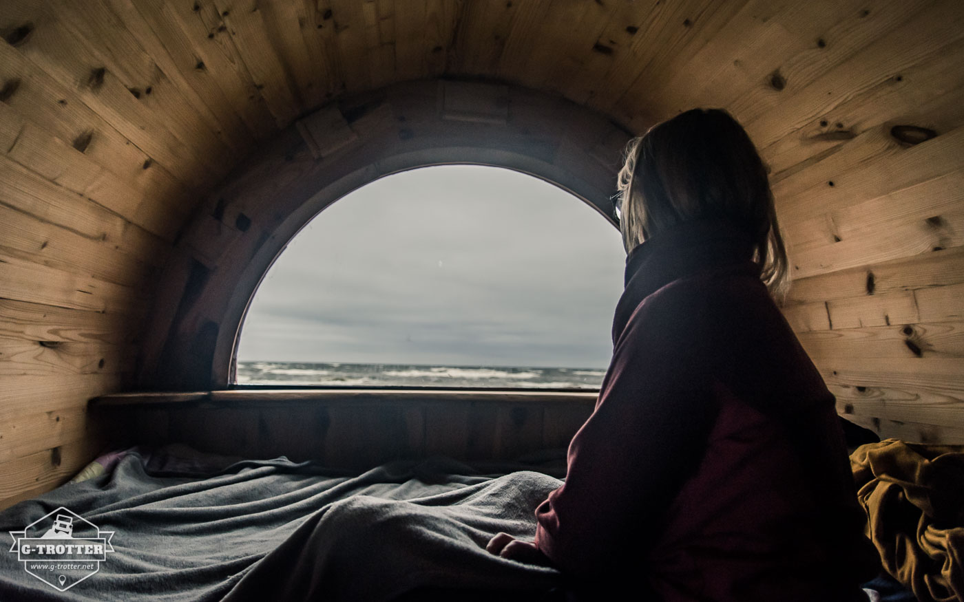 The view of the stormy sea from the window of the wine barrel.