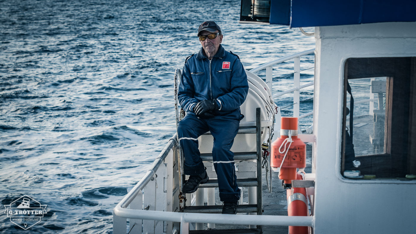 The chilled boatsman has an eye on the ocean.